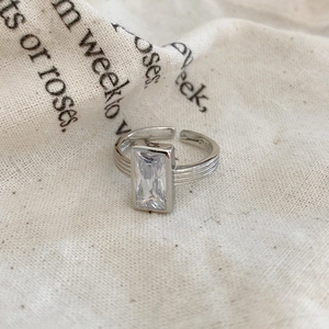 Macro shot of 925 silver ring featuring rectangular zircon and textured band finish