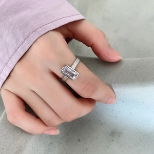 Macro detail of 925 sterling silver ring with rectangular zircon and textured band