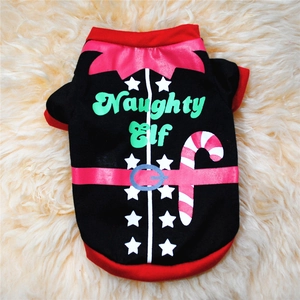 Flat lay detail of a Christmas pet vest featuring Naughty Elf print on plush background