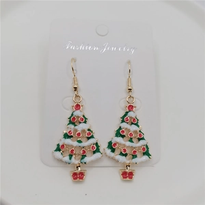 Close-up of Christmas tree drop earrings with green enamel and golden hooks