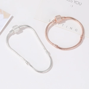 Classic silver and rose gold snake chain bracelet set with cylindrical clasps