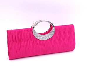 Detail of rose pink pleated evening bag featuring a rhinestone studded metal handle