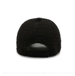 Detail of black faux shearling baseball cap showing the adjustable back strap and texture