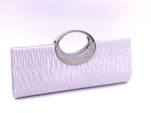 Detail of lavender pleated evening bag featuring a rhinestone-embellished metal handle
