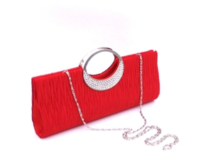 Detailed view of red pleated evening clutch bag with rhinestone metal handle and silver chain