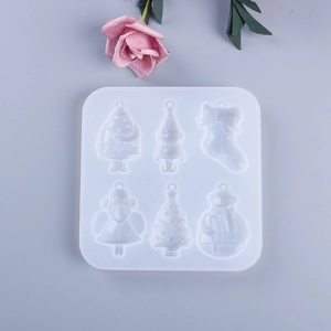 Close-up of a 6-cavity Christmas silicone mold for DIY resin pendants with tree and snowman