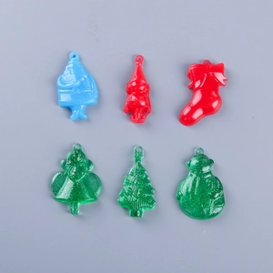 Detail of Christmas resin pendant charms featuring Santa and glitter snowman DIY designs