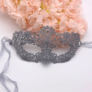 Detailed silver lace masquerade mask with glitter finish on white background