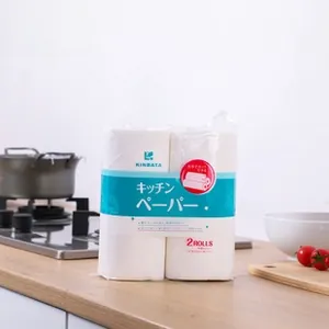 Detail view of two rolls of white kitchen paper towels on a clean wooden countertop