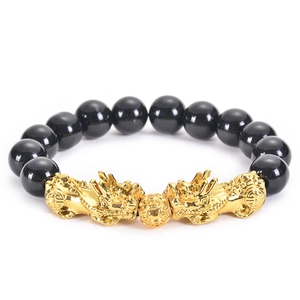 Detail of black obsidian beads and two golden PiXiu charms with a lucky transfer bead