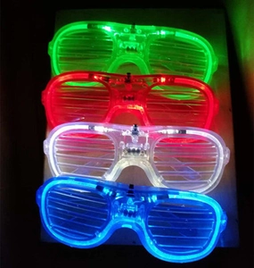 Detail of LED shutter glasses in four glowing colors green red white and blue for parties