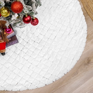 White faux fur Christmas tree skirt with silver sequin diamonds on wood floor