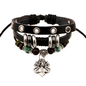 Close-up of layered leather bracelet with silver anchor charm and wood beads