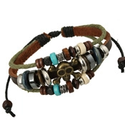 Detail of woven leather and military green rope bracelet with bronze skull and wooden beads