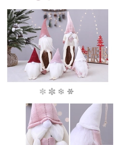 Close-up of festive Christmas gnomes in knitted fabric with Merry Christmas wooden sign