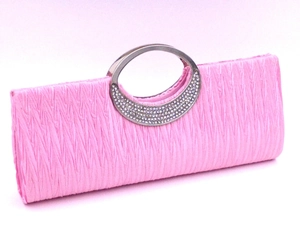 Detail of pink pleated evening clutch bag with sparkling rhinestone encrusted silver metal handle