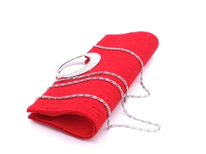 Detail of red pleated evening bag with rhinestone studded silver metal handle and chain