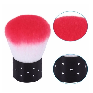 Detailed view of large makeup brush with pink gradient bristles and black polka dot handle