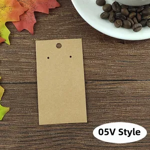 Detail of 05V Style brown kraft paper earring display card on dark wood background