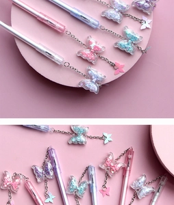 Detail of glitter butterfly charm and translucent barrel on colorful gel pens