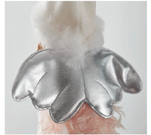 Detailed close-up of silver angel wings and soft plush white fabric for Christmas decor