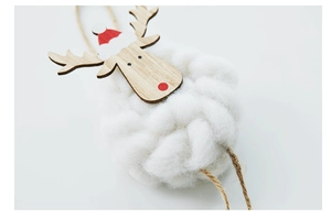 Detail of wool felt reindeer ornament with wooden head and red hat for Christmas decor