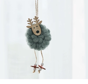 Detail of a handmade wool felt reindeer ornament with wooden head and hemp rope hanger
