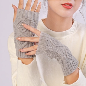 Close-up of grey cable knit fingerless gloves with elastic ribbed cuffs for women