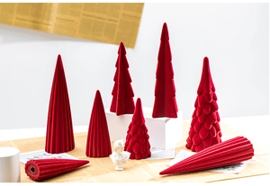 Detail of red flocked ceramic Christmas tree ornaments with soft velvet texture