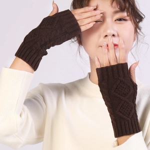 Detail of brown diamond cable knit pattern on warm winter fingerless gloves