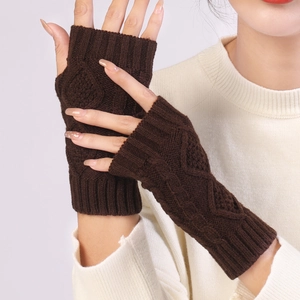 Detail of dark brown cable-knit fingerless gloves with thick texture and ribbed cuffs