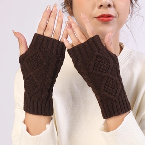 Close-up of dark brown knit fingerless gloves with a diamond pattern and ribbed cuffs
