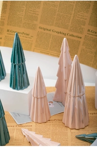 Glossy ceramic Christmas tree set in dark green and pink on a white display base