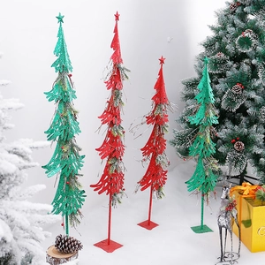 Modern metallic Christmas tree ornaments in red and green for festive window displays