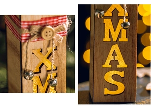 Close-up of wooden XMAS lightbox with warm LED light, linen bow and festive bell details