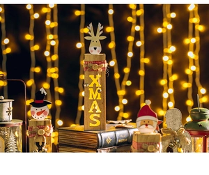 Macro shot of wooden Xmas ornament with LED lighting and reindeer snowman figures