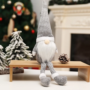 Nordic Christmas gnome plush doll in gray and white sitting on a wooden stand