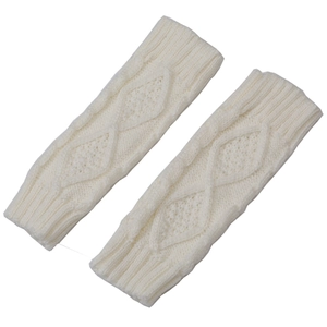Close-up of cable knit texture on cream diamond pattern fingerless gloves arm warmers