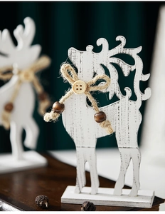 Detail of white wooden Christmas reindeer with jute bow and rustic texture decoration