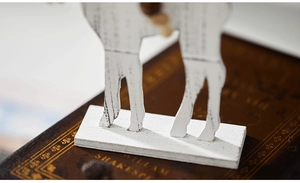 Close-up of white wooden reindeer base with rustic texture and vintage background