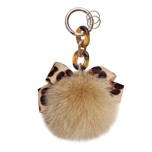Brown faux fur keychain with leopard print bow and amber resin chain links on white background