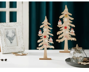 Detail of wooden Christmas tree owl tabletop decorations in set of two for festive desk decor