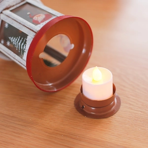 Christmas iron lantern with LED candle featuring Santa and cedar patterns on wood base