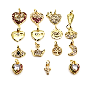 Golden charms collection with heart, moon, and tree motifs featuring micro zircon inlay