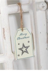 Macro detail of wooden Merry Christmas tag with silver glitter star and rustic hemp rope