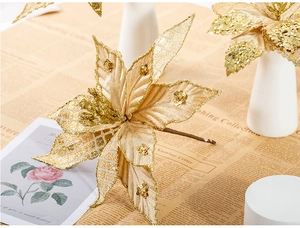 Close-up of a 30cm gold Christmas poinsettia with sequins on vintage newspaper background