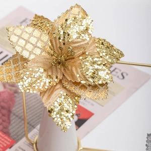 Golden artificial Christmas flower with glitter texture for festive interior decoration