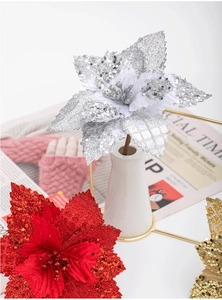 Close-up of glittered artificial poinsettia flowers in silver, red, and gold for Xmas