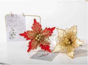Detail of red and gold Christmas artificial flower with mesh texture and glitter