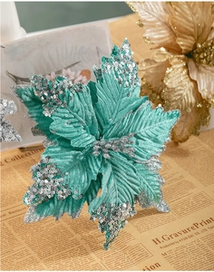 Close-up of tiffany blue artificial Christmas flower with silver sequins on vintage background